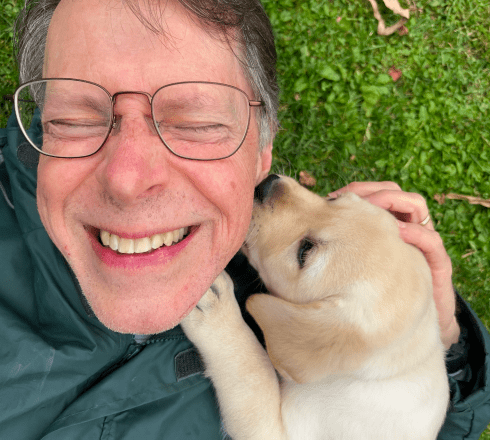 Ross Gill, owner of Catskill Mountain Labradors with his champion english labrador pup on his home property